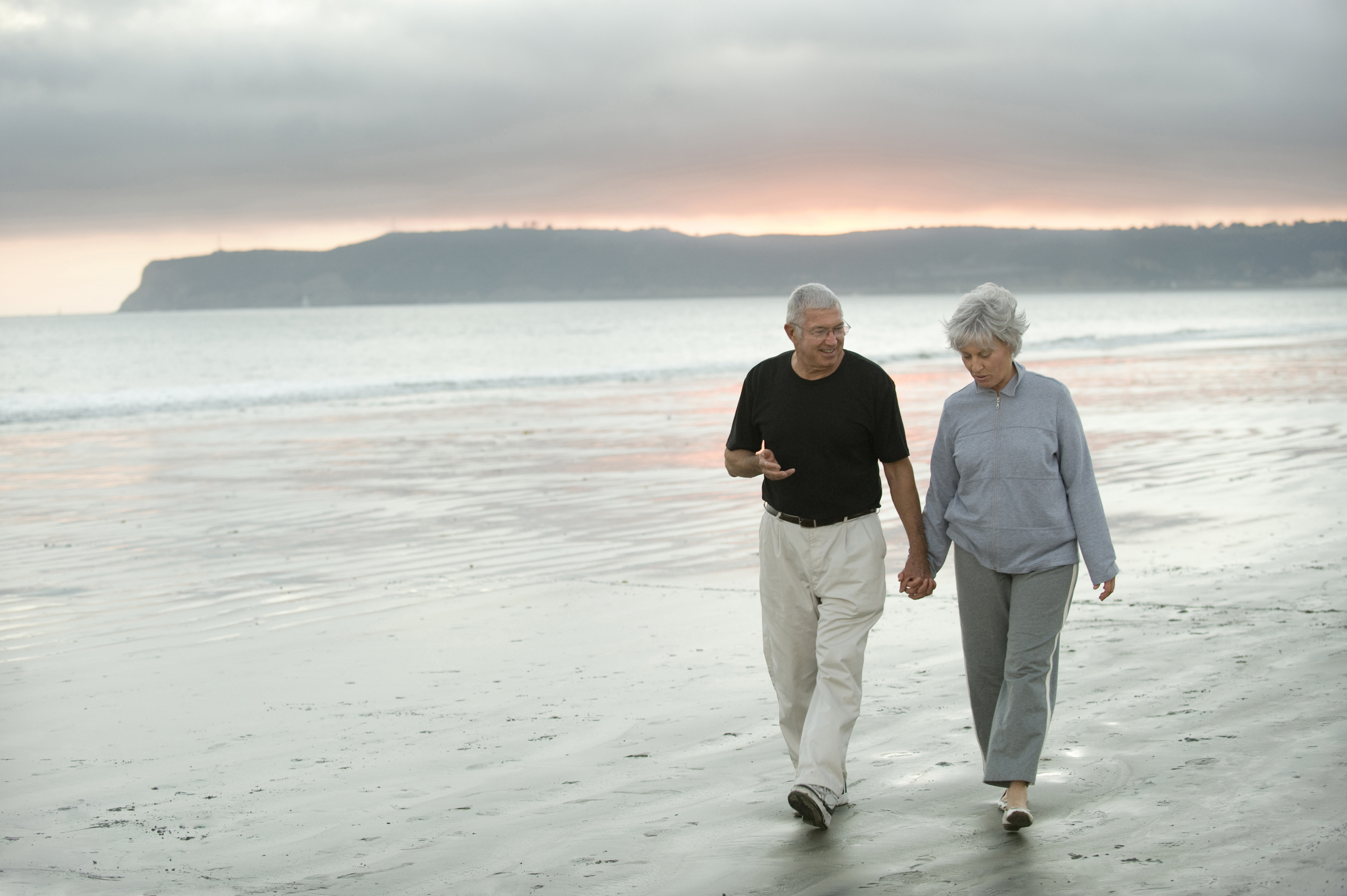 A couple walking along a deserted beach