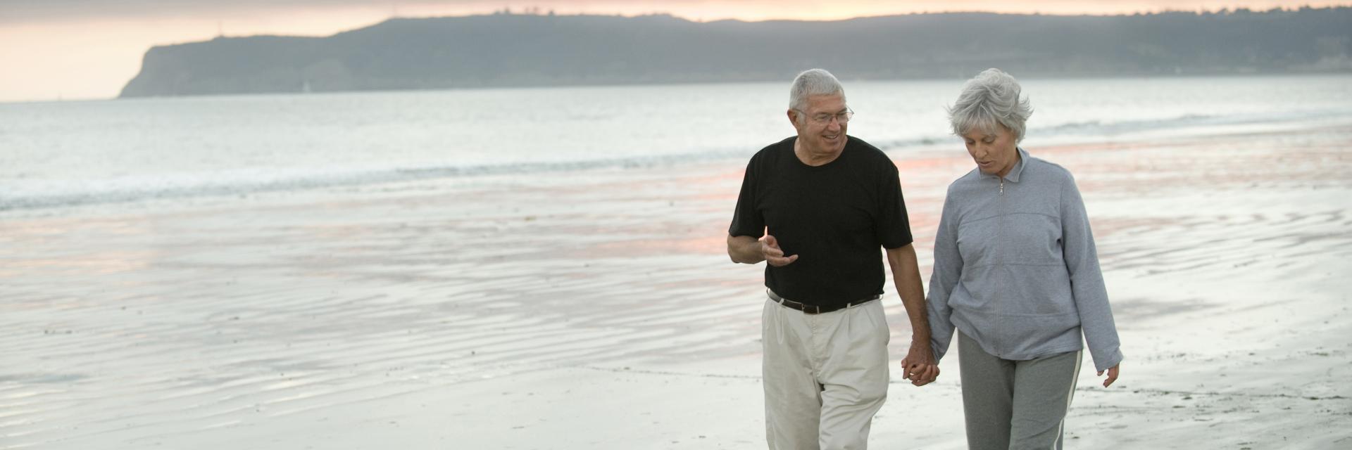 A couple walking along a deserted beach