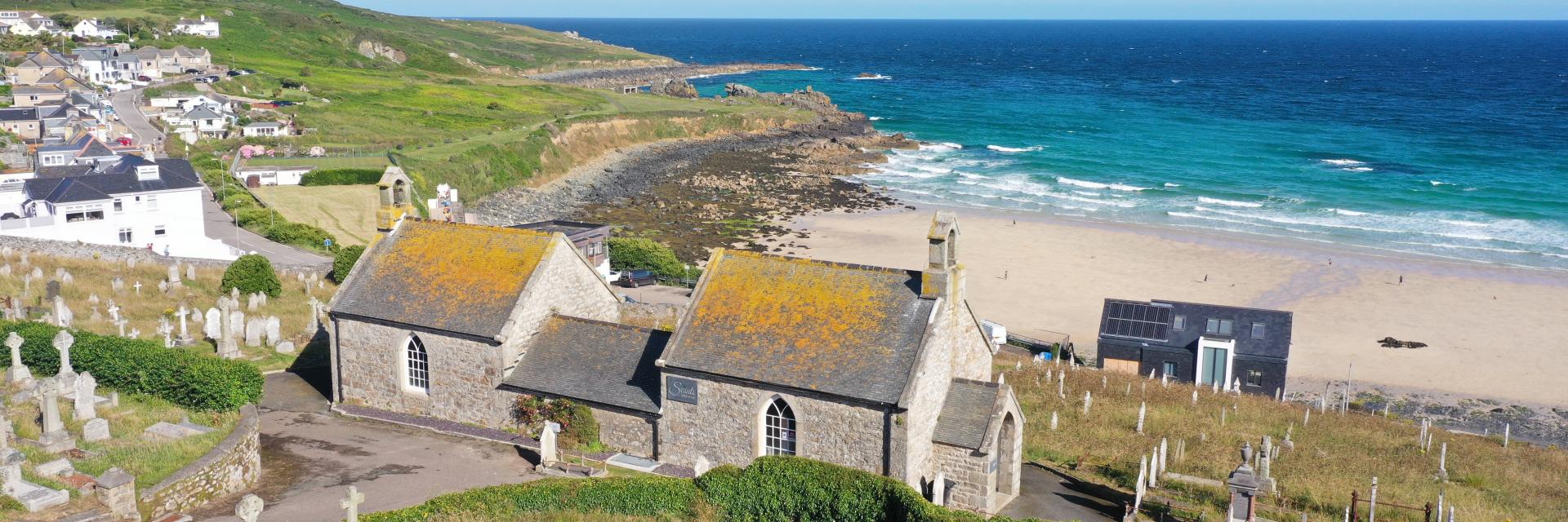 View of chapel with cemetry in the foreground and ocean in the background